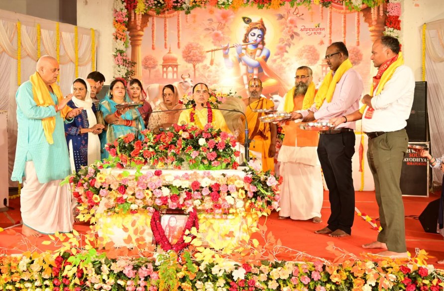 Devotees offering aarti on a flower-decorated stage
